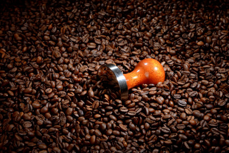 Coffee beans with tamper. Coffee business concept