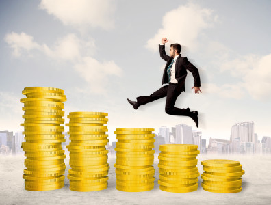 Successful business man jumping up on gold coin money